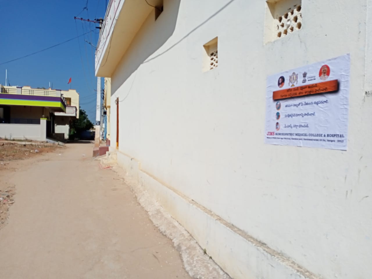 Janandolan Campaign On COVID 19 - IEC Poster Sticking At Rangapur Village Of Kothur Mandal