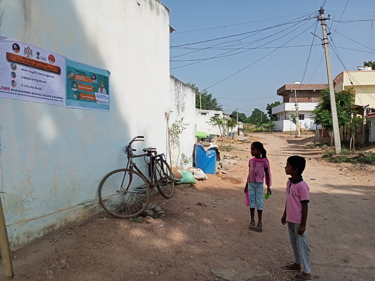 Janandolan Campaign On COVID 19 - IEC Poster Sticking At Manchan Padu Village. This Is Another Hamlet Village Of Modallaguda Panchayath
